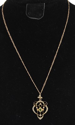 Lot 1209 - An Edwardian 9ct yellow gold peridot and seed...