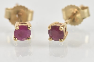 Lot 1255 - A pair of 9ct yellow gold ruby set earrings,...