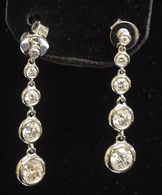 Lot 1235 - A pair of 18ct white gold diamond five stone...