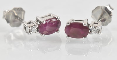 Lot 1248 - A pair of 9ct white gold ruby and diamond set...
