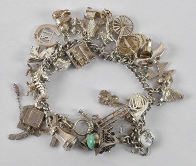Lot 1321 - A 925 hallmarked silver charm bracelet, with...