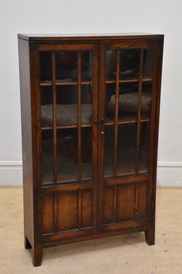 Lot 2207 - An early 20th century oak bookcase, with a...