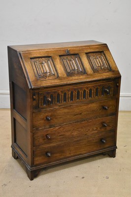 Lot 2174 - A reproduction oak bureau with linenfold fall...