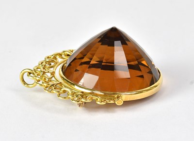 Lot 1076 - A large faceted circular citrine in an 18ct...
