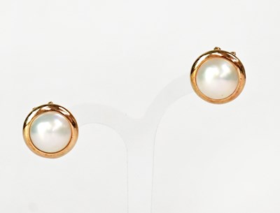 Lot 1096 - A pair of half Mabé pearl earrings in 14ct...