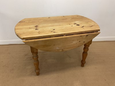Lot 791 - A circular pine drop flap table, height 79cm,...