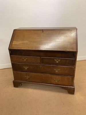 Lot 709 - A Georgian oak bureau, with arrangement of...