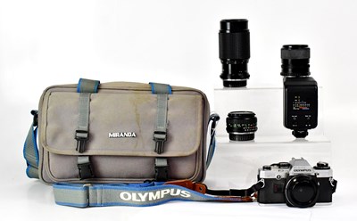 Lot 413 - OLYMPUS; an OM10 camera with two instruction...
