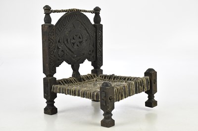 Lot 1848 - A 19th century carved Afghan low chair, height...