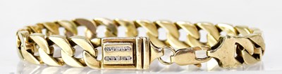 Lot 1056 - A 9ct yellow gold curb link bracelet, with one...