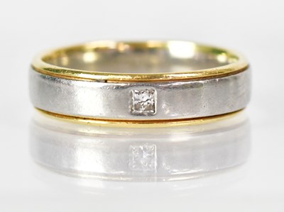 Lot 1017 - A platinum and gold wedding band set with a...