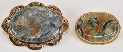 Lot 1548 - Two moss agate brooches, the central oval...