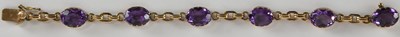 Lot 1588 - A 9ct gold amethyst set line bracelet, with...