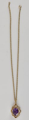 Lot 1402 - An oval cut amethyst set in a 9ct gold open...