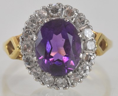 Lot 1149 - An 18ct gold diamond and amethyst set ring,...