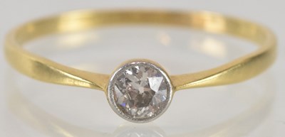 Lot 1170 - An 18ct gold diamond solitaire ring, the bezel...