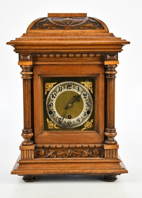 Lot 2253 - An early 20th century carved oak mantel clock,...