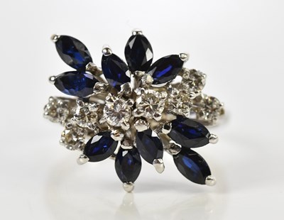 Lot 54 - A white metal sapphire and diamond cluster...