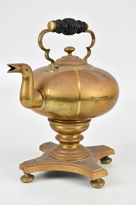 Lot 1396 - A brass kettle on a stand, height 37cm.