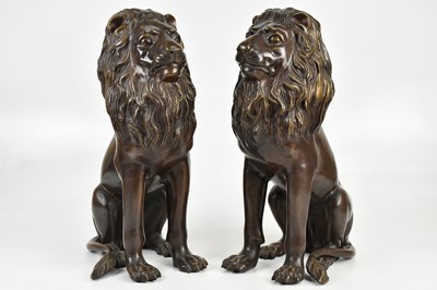 Lot 1402 - A pair of bronze seated lion figures, height...