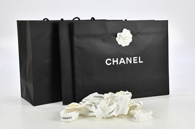 Lot 705 - CHANEL; three matte black shopping bags, with...