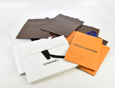 Lot 699 - CHANEL; two large matte black shopping bags...