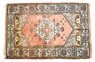 Lot 125 - A Caucasian wool rug of terracotta ground,...