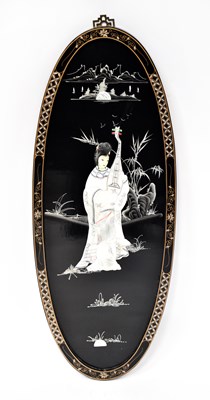 Lot 273 - A Chinese oval lacquered wall panel inlaid...