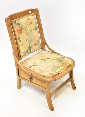 Lot 29 - An early 20th century oak nursing chair, with...