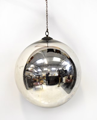 Lot 337 - A large silver-coloured glass bauble on a...