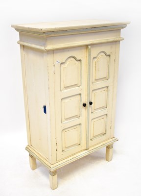 Lot 76 - A painted floorstanding cupboard with fielded...