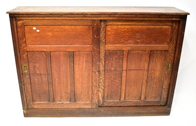 Lot 99 - An Edwardian oak floorstanding bookcase, with...