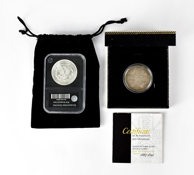 Lot 944 - An 1889 silver uncirculated Morgan dollar,...
