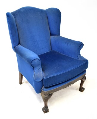 Lot 30 - An early 20th century wingback armchair, with...