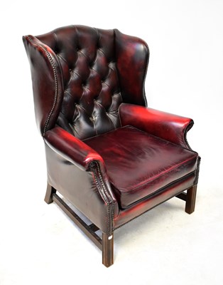 Lot 31 - An oxblood leather button pressed wingback...