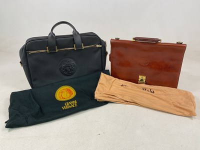 Lot 155 - An Italian tan leather briefcase and a Versace...
