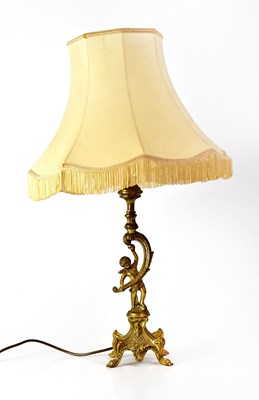 Lot 141 - A brass-effect table lamp with a boy holding...