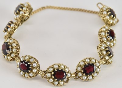 Lot 1584 - A 9ct gold garnet and seed pearl cluster...