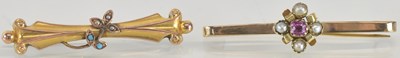Lot 1557 - Two 9ct gold bar brooches, one with ruby and...