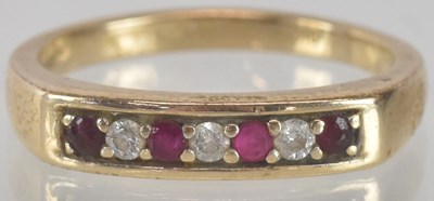 Lot 1345 - A 9K yellow gold ring, with four ruby and...