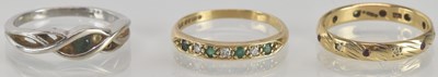 Lot 1283 - Three 9ct gold dress rings, one set with green...