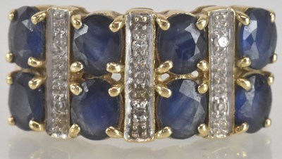 Lot 1245 - A 9ct gold dress ring, with two double rows of...
