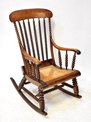 Lot 41 - A 19th century oak rocking chair with rattan...