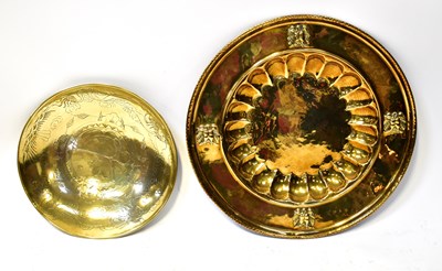 Lot 857 - A large brass charger, with hammered effect...
