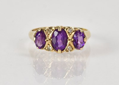 Lot 1050 - A 9ct yellow gold ring set with three...