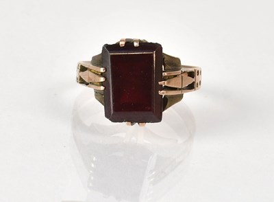 Lot 1054 - A yellow metal ring set with an emerald cut...