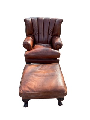 Lot 2077 - A modern brown leather lounge chair with...