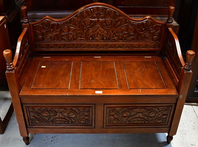 Lot 23 - A modern wooden bench, with carved panels and...