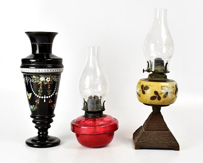 Lot 130 - A Victorian cranberry glass oil lamp well with...