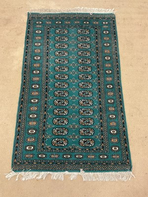 Lot 682 - A Pakistani Bokhara green rug, 154 x 91cm.
